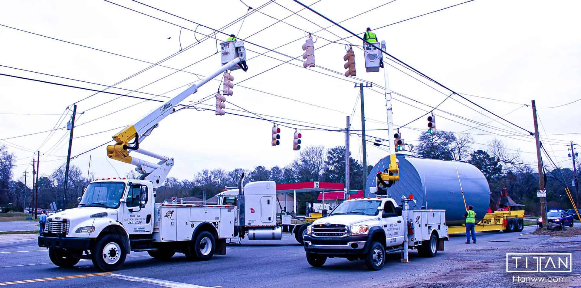 Superload Haulers Escorted by Bucket Trucks