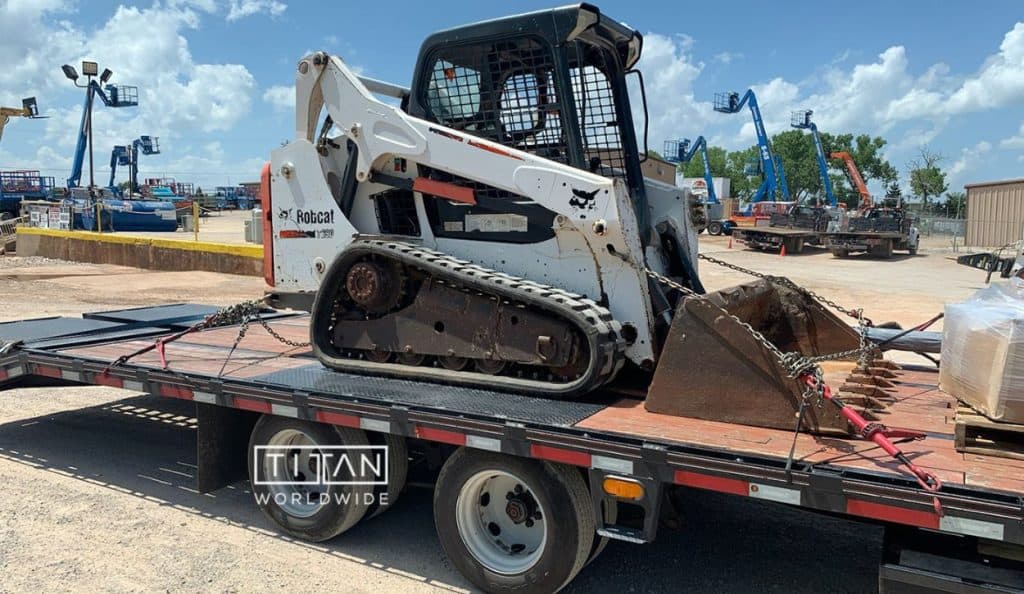 Skid steer secured on a flatbed trailer
